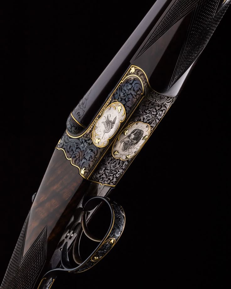 Engraved sporting shotgun with walnut stock against a black background